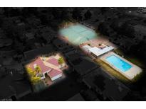 Night aerial view of community featuring a home, pool, and tennis courts at 726 Sea Pines Ln, Las Vegas, NV 89107