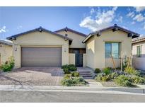 Charming single-story home with desert landscaping and a two-car garage with brick paved driveway at 97 Sarabeth St, Las Vegas, NV 89138