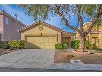 Charming single-story home featuring a well-maintained yard and attached two car garage at 212 Duck Hollow Ave, Las Vegas, NV 89148