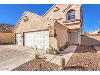 Two-story stucco home showcasing a two-car garage, tiled roof, and low-maintenance landscaping at 4125 Glenfield Cir, Las Vegas, NV 89129