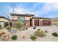 Charming single-story home featuring a stone facade, desert landscaping, and a three-car garage at 4509 Westmere Ave, North Las Vegas, NV 89084