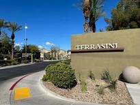 Community entrance sign with well-maintained landscaping, mature palm trees, and clear blue skies at 4720 Basilicata Ln # 101, North Las Vegas, NV 89084