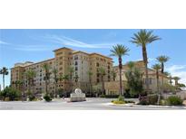 Expansive view of a luxury apartment building with desert landscaping and beautiful palm trees at 2405 Serene Ave # 241, Las Vegas, NV 89123