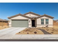 Charming single-story home with a low-maintenance desert landscape and attached two-car garage at 3924 E Garfield Dr, Pahrump, NV 89061