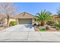 Charming stucco home featuring mature landscaping, a two-car garage, and a paved driveway at 4012 Shetland Pony St, Las Vegas, NV 89122