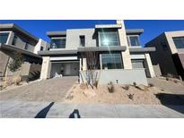 Modern two-story home featuring a two-car garage, desert landscaping, and contemporary architectural details at 4880 Argento Peak St, Las Vegas, NV 89135