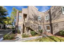 Inviting condo exterior featuring an elevated entrance, neutral stucco, and well-maintained landscaping at 5250 S Rainbow Blvd # 1162, Las Vegas, NV 89118