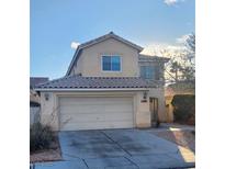 Charming two-story home featuring a two-car garage, neutral stucco, and a tile roof at 5830 Springmist St, North Las Vegas, NV 89031
