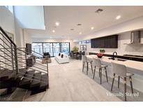 Bright, open living area featuring a modern kitchen, dining space, and comfortable seating, all bathed in natural light at 9 Promenade Isle Ln, Henderson, NV 89011