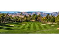 Scenic golf course with lush green fairways, mature trees and mountain views at 9044 Opus Dr, Las Vegas, NV 89117
