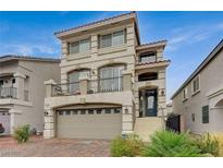 Beautiful three-story home with a two-car garage, balcony, and stylish architectural details at 9835 Fox Estate St, Las Vegas, NV 89141
