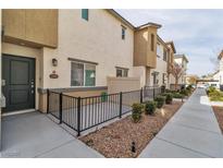 Charming townhome features a private, fenced-in front patio and modern exterior finishes at 12268 Desert Light Rd # 1, Las Vegas, NV 89183