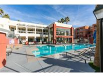 Resort-style pool and lounge area with modern architecture and manicured landscaping at 23 E Agate Ave # 303, Las Vegas, NV 89123