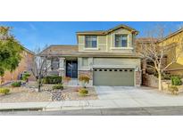 Charming two-story home featuring stone accents, a well-manicured yard, and a two-car garage at 2752 Blairgowrie Dr, Henderson, NV 89044