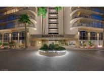 Elegant Regency Towers entrance featuring a lush roundabout and well-maintained landscaping at 3111 Bel Air Dr # 15D, Las Vegas, NV 89109