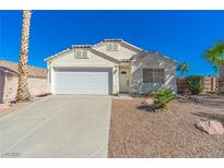 Charming single-story home with a well-maintained front yard and a two-car garage at 320 Island Reef Ave, Henderson, NV 89012