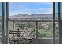 A stunning balcony view features outdoor seating, verdant trees, a golf course and mountains in the distance at 322 Karen Ave # 2206, Las Vegas, NV 89109