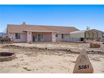 Charming single-story home with a desert landscape and covered parking area at 3581 Ranger Way, Pahrump, NV 89048