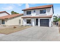 Charming two-story home with a well-maintained front yard and a single-car garage at 374 Tierra St, Henderson, NV 89014