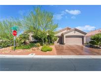 Charming single-story home featuring a well-manicured front yard, desert landscaping, and a two-car garage at 4014 Trapani Pl, Las Vegas, NV 89141