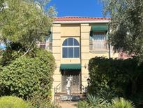 Charming two-story home featuring a red tile roof, lush greenery, and inviting curb appeal at 5740 N Park St, Las Vegas, NV 89149
