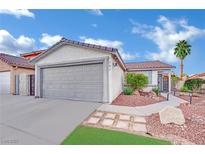 Charming single-story home with a well-manicured front yard and a two-car garage in a desirable neighborhood at 585 Jackson Dr, Henderson, NV 89014