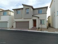 Charming two-story home featuring neutral-toned stucco, brick-lined driveway, and a convenient attached garage at 6840 Sunflower Fields St, North Las Vegas, NV 89086