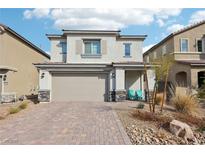 Charming two-story home featuring a brick driveway, desert landscaping, and a welcoming covered front porch at 6844 Bayou Hollow Ave, Las Vegas, NV 89156