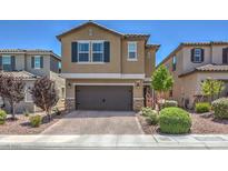 Two-story home boasts a symmetrical facade, a two-car garage, and a beautifully landscaped front yard at 9201 Nanjing Ave, Las Vegas, NV 89148