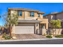 Inviting two-story home with a two car garage, desert landscaping, and a paved driveway at 9672 Sunstone Sparkle Ave, Las Vegas, NV 89148