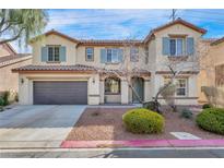 Charming two-story home with a well-manicured front yard and attached two car garage at 1009 Rustridge Ave, North Las Vegas, NV 89081