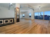 Bright living room with hardwood floors and large windows showcasing a stunning city view at 200 Hoover Ave # 1505, Las Vegas, NV 89101