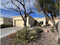 Charming single-story home featuring desert landscaping, a two-car garage, and a welcoming entrance at 2227 Hallston St, Las Vegas, NV 89134