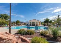 Resort style community pool with lounge chairs and covered seating area, perfect for relaxing in the sun at 2345 Cliffwood Dr, Henderson, NV 89074