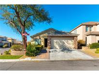 Charming single-story home with stone accents, a two-car garage, and a well-manicured front yard at 2461 Daks Loden Ct, Henderson, NV 89044