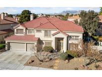 Stunning two-story home featuring a red tile roof, manicured landscaping, and a spacious three-car garage at 2637 Ohio Ct, Las Vegas, NV 89128