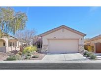 Charming single-story home with a two-car garage and desert landscaping at 4217 Gliding Gulls Ave, North Las Vegas, NV 89084
