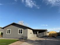 Charming single-story home features a gray exterior, covered carport, and well-maintained artificial lawn at 5194 Saratoga Dr, Las Vegas, NV 89120