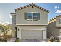 Charming two-story home featuring a two-car garage and a nicely landscaped front yard at 5399 El Nevero St, Las Vegas, NV 89166