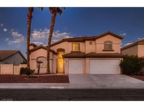 Two-story home featuring a two-car garage, front yard with palm trees, and a warm, inviting exterior paint color at 5416 Irish Spring St, Las Vegas, NV 89149