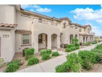 Inviting townhome featuring stucco exterior, arched entry, and well-maintained landscaping at 56 Lomita Heights Dr, Las Vegas, NV 89138