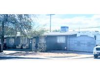 Modest single story home featuring a gated entry, mature trees, and an enclosed front yard at 5617 Tanya Ave, Las Vegas, NV 89107