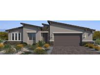 Charming single-story home featuring a two-car garage, stone accents, and desert landscaping in a modern style at 6312 Zephyr Ct, Las Vegas, NV 89149