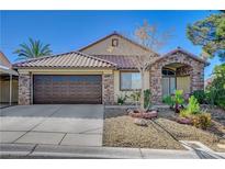 Charming single-story home featuring desert landscaping, a brick facade and a two-car garage at 6587 Lucky Boy Dr, Las Vegas, NV 89110
