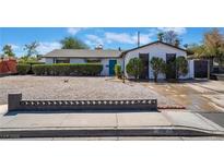 Charming single-story home with gravel landscaping, trimmed bushes and a well-maintained front yard at 941 E Hacienda Ave, Las Vegas, NV 89119