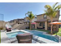 Inviting backyard with a sparkling pool, stylish patio furniture, and lush landscaping at 12553 Skylight View St, Las Vegas, NV 89138
