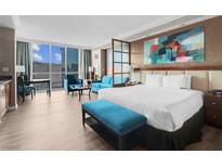 This cozy bedroom features large windows, modern furniture, and a bright and spacious layout at 145 E Harmon Ave # 2603, Las Vegas, NV 89109