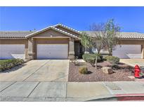 Charming townhome featuring a two-car garage, desert landscaping, and a welcoming front entry at 211 Crown Imperial St, Henderson, NV 89074