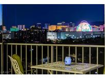 Balcony view showcasing the Las Vegas skyline at night with outdoor seating at 3111 Bel Air Dr # 12C, Las Vegas, NV 89109