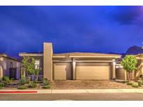 Home exterior at dusk showcases a two-car garage, desert landscaping, and a modern architectural style at 415 Point Sur Ave, Las Vegas, NV 89138